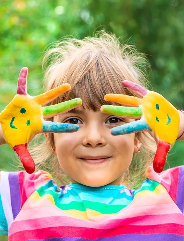 Young girl with smiles painted on her hands